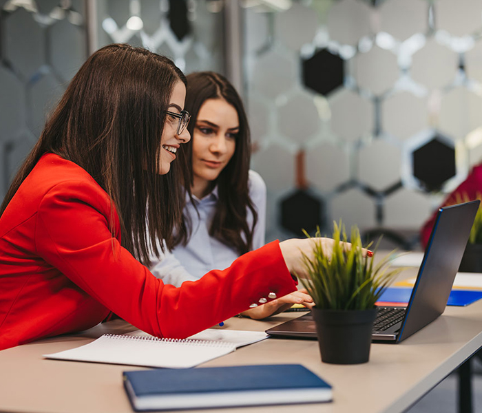 Two women looking at laptop