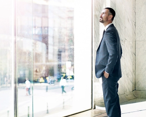 A man standing in front of the window